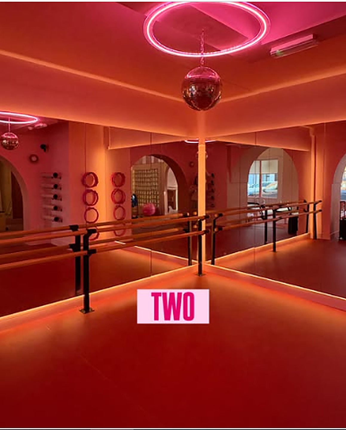 The neon-lit Øra barre studio with a disco ball